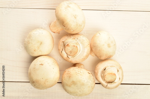 Freshly cut mushrooms, close-up, on a white wooden table.