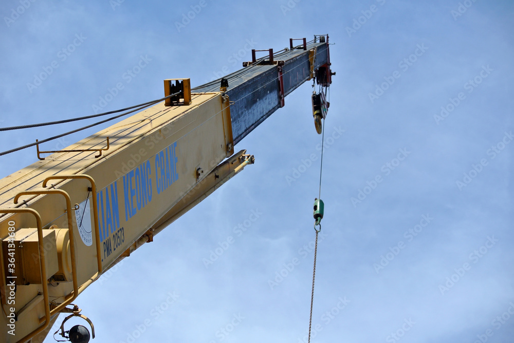 JOHOR, MALAYSIA -FEBRUARY 26, 2016: Mobile crane boom with hooks and scale weight above blue sky. The boom used to lifting heavy load. 