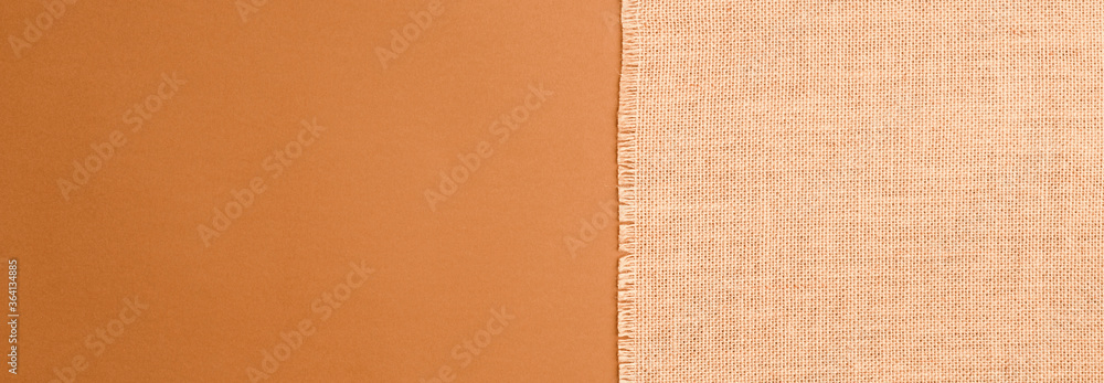 Fototapeta premium panoramic photo Natural linen texture, brown background top view.