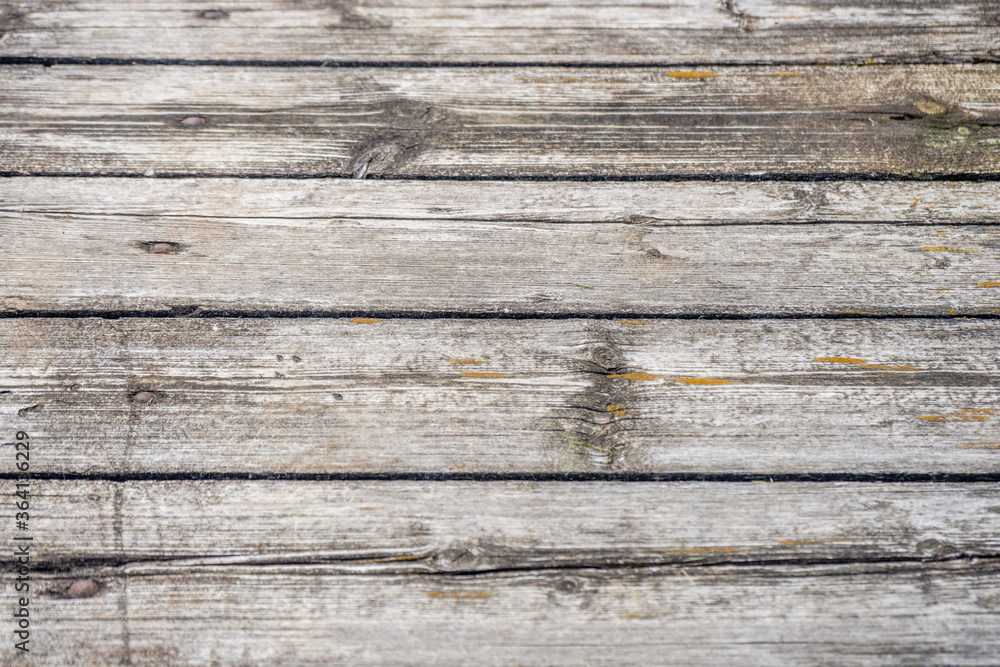 A wooden bench sitting next to a fence A wooden bench sitting next to a fence