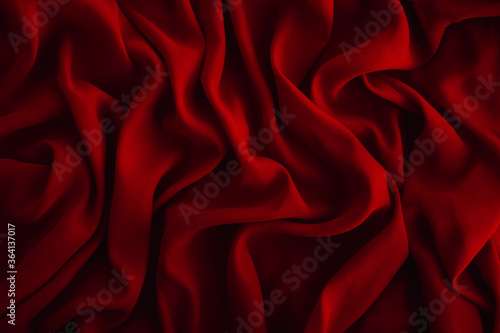 Red fabric texture. Dark abstract background for design. Close up, copy space, top view