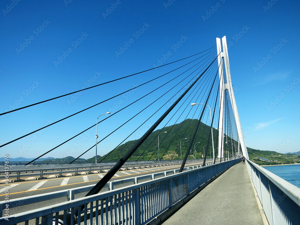 The cycle lane of Tatara Bridge (多々羅大橋, Tatara Ohashi) above Seto Inland Sea, JAPAN. A cable-stayed bridge as part of Shimanami Kaido expressway and cycling route The cycle lane of Tatara Bridge (多々羅大橋, Tatara Ohashi) above Seto Inland Sea, JAPAN. A cable-stayed bridge as part of Shimanami Kaido expressway and cycling route