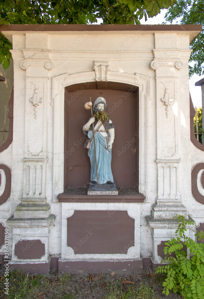 Figurine of St. James placed on the pilgrimage route to Santiago de Compostela (Camino) near the church of St. Jakub in Saczow in Poland.