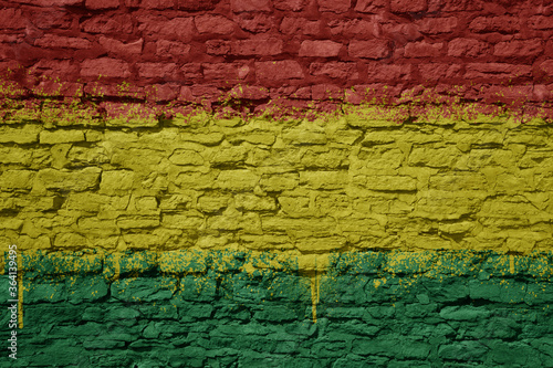 painted big national flag of bolivia on a massive old brick wall © luzitanija