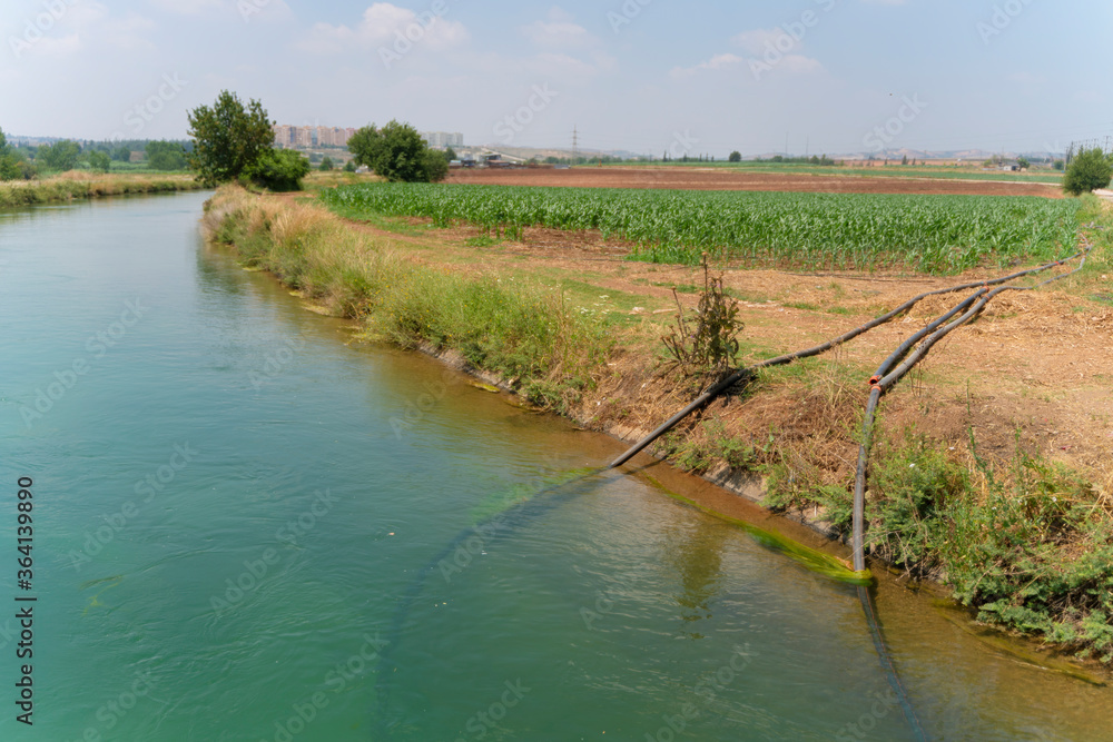 The pumping station where water is pumped from a irrigation canal, and distributed to irrigation sprinklers in farm fields.