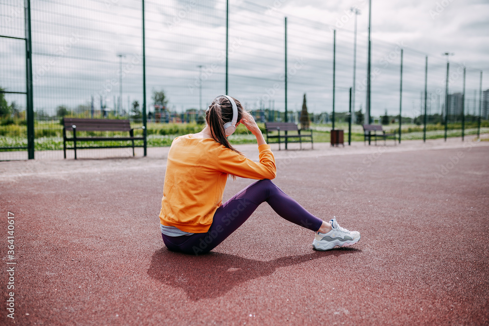 Woman doing sport on the court. Woman seatting and listening to music outside.