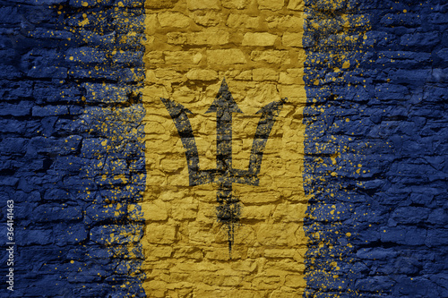 painted big national flag of barbados on a massive old brick wall