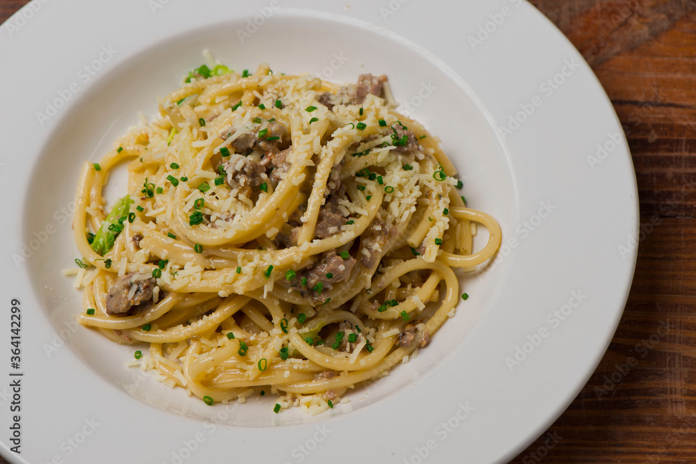 Pasta with meatballs, marinara sauce, Parmesan cheese and fresh Italian parsley. Classic American or Italian restaurant favorite. Homemade pasta with sauces, meats and cheeses.