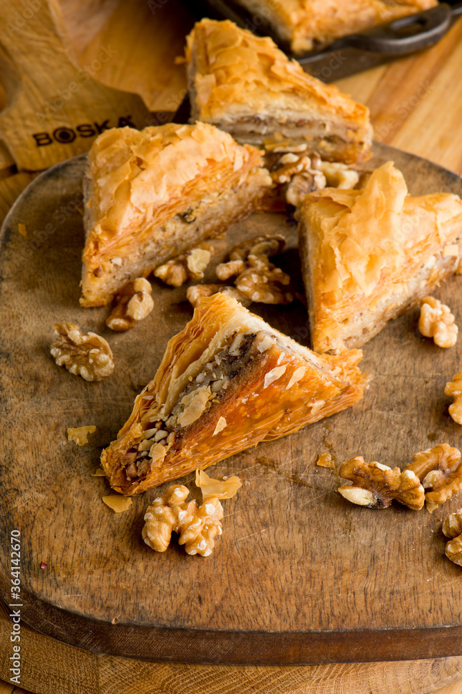 Fototapeta premium Baklava. A classic traditional rich and sweet mediterranean, Greek or Turkish, dessert pastry made of layers of filo filled with chopped nuts and sweetened and held together with syrup or honey.