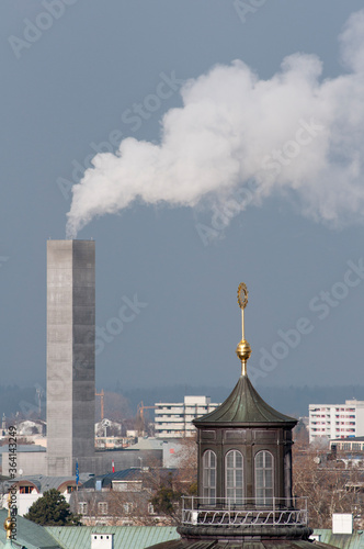 Chimney smoke with old town church spire