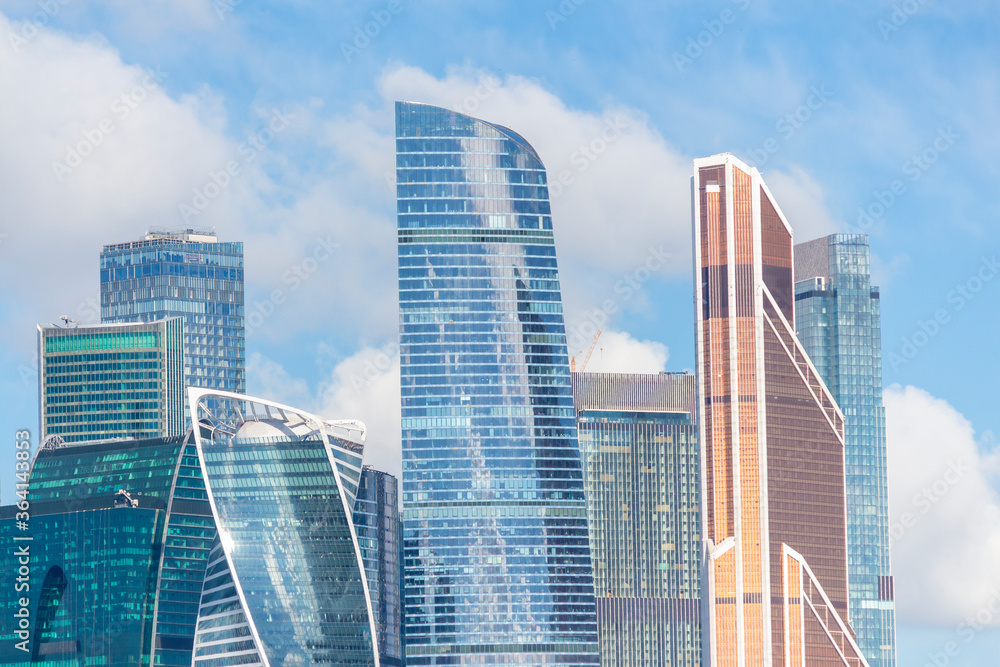 Cityscape of Moscow city with skyscrapers of Moscow International Business Center (MIBC). Blue sky with few clouds on a summer morning. Modern office buildings theme.