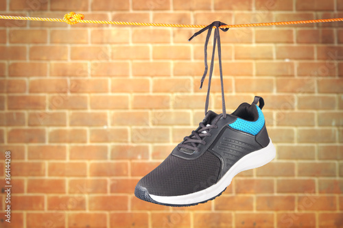 Men's Sport shoes hanging on rope   © V.R.Murralinath