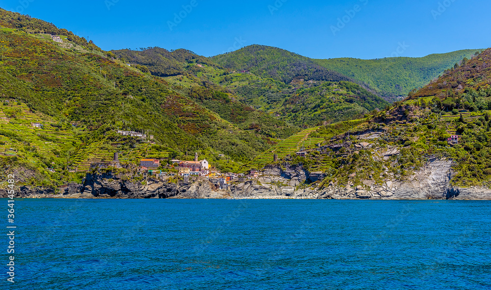 A panorama view from the sea approaching the Cinque Terre village of Vernazza in the summertime