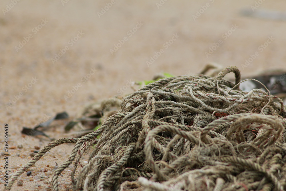 A pile of old ropes that had been washed away by the sea by the beach A pile of old ropes that had been washed away by the sea by the beach