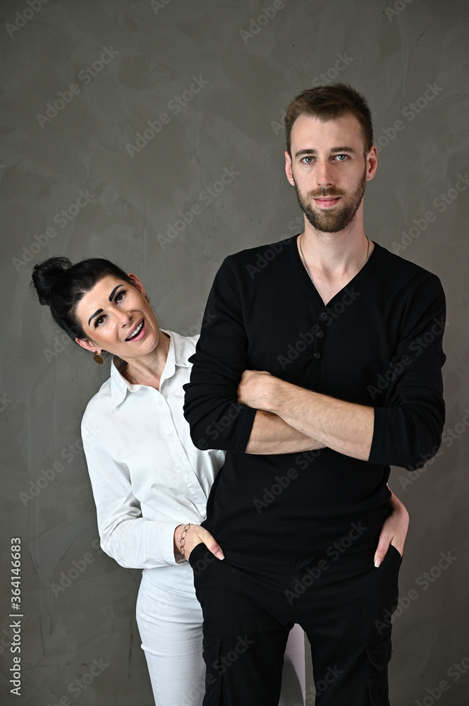 Studio portrait of a caucasian brunette woman and a man in a love relationship with a smile and happiness Studio portrait of a caucasian brunette woman and a man in a love relationship with a smile and happiness