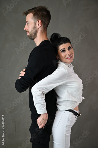 Studio portrait of a caucasian brunette woman and a man in a love relationship with a smile and happiness