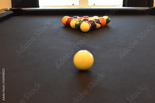 Black billiard table  Playing snooker pool 8ball - Close-up shot of a man playing billiard