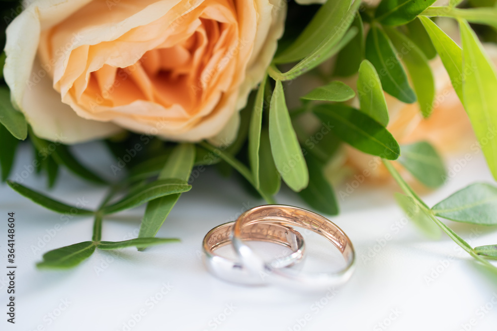 Two wedding rings in yellow and white gold, engraved with the Latin words Two wedding rings in yellow and white gold, engraved with the Latin words