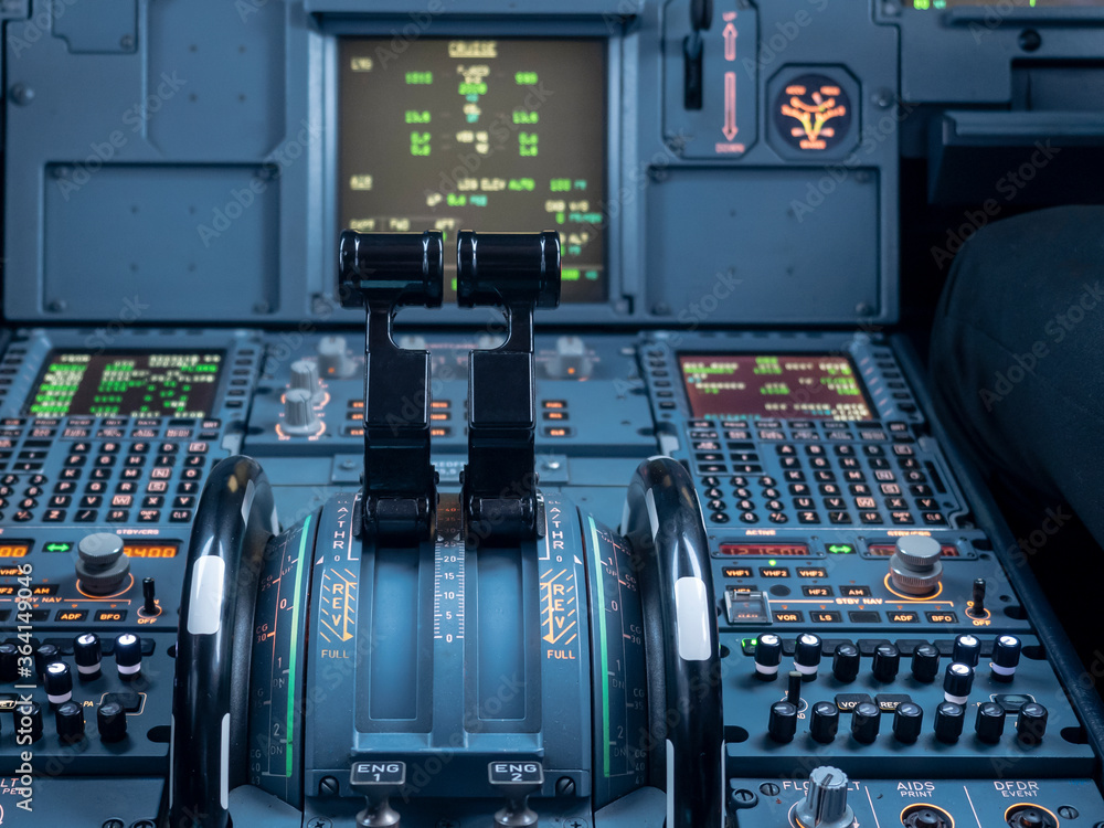 Airbus A320 thrust levers on the centre pedestal instrument panel. Switches  and dials visible in the background. Stock Photo | Adobe Stock