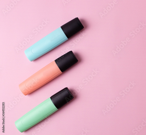 three colorful highlighter markers