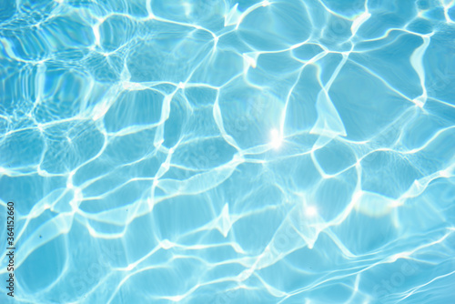 Pool water background with abstract waves and sparkles.