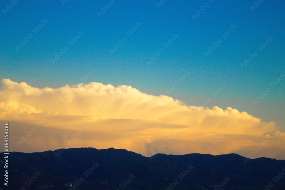 nice landscape with illuminated white clouds on blue sky background nice landscape with illuminated white clouds on blue sky background