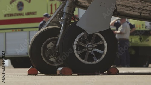 Old helicopter chassis on the ground with grass
