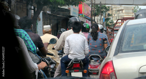dense traffic in the streets of Hyderabad India with motorcycles and cars moving slowly