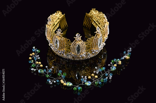 Handmade bead crown on a black background. Handmade jewelry set for special occasions, photo shoots and fashion shows. Handmade hair jewelry. Selective focus.