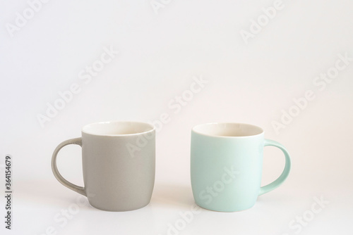 Two mugs on white background with copy space.