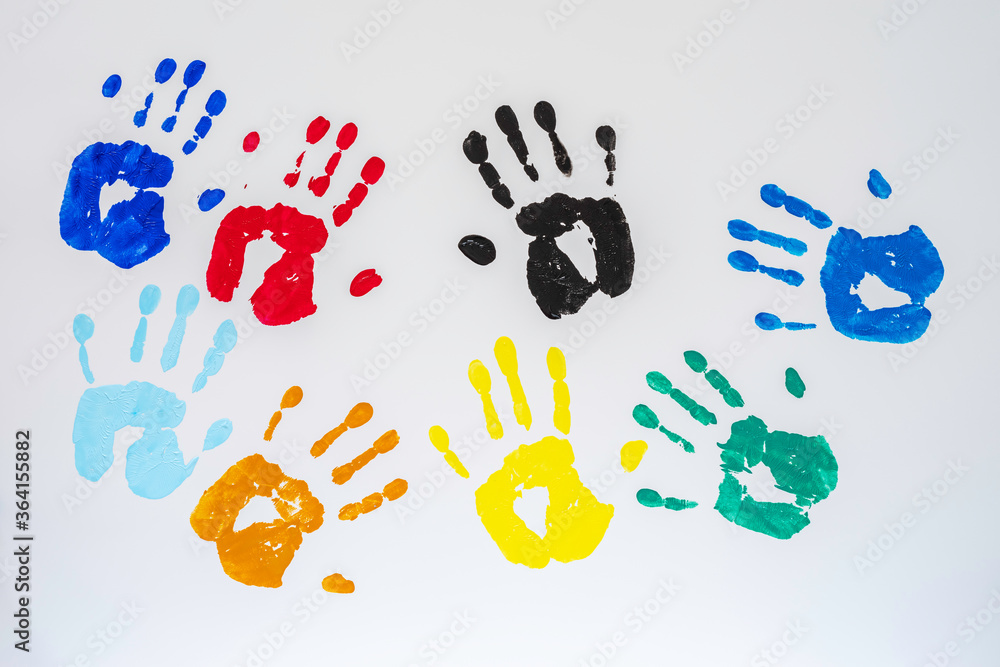 Handprints of various colours on white background. Handprints of various colours on white background.