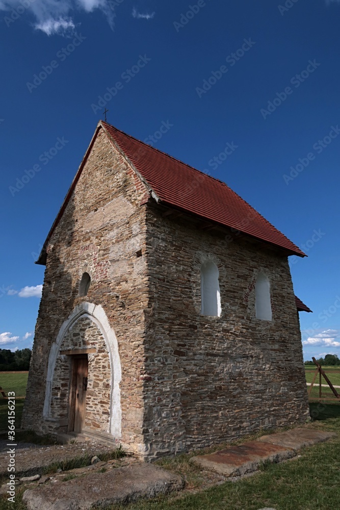 Front side view of pre-romanese Church of Saint Margaret of Antioch, Kopcany, on boundary between Czech Republic and Slovakia, near Morava river, in summer daylight sunshine. 