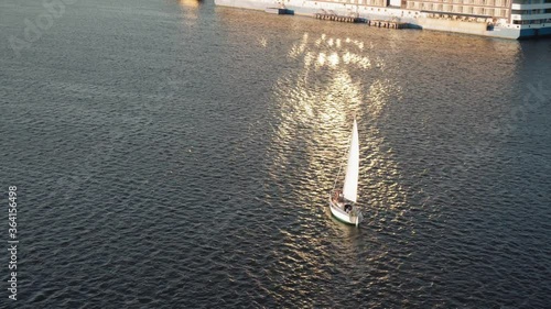 Transprt, reservoirs, travel, navigation concept - aerial survey from height bridge ower pond with boats ships yachts and other tourist water vessels on wide river Dnipro in Kiev at sunset. photo