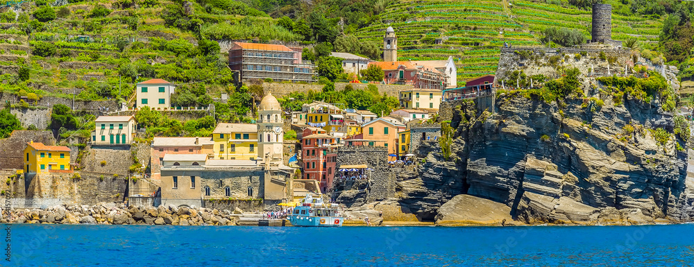 A panorama view towards the harbour in the colourful Cinque Terre village of Vernazza in the summertime