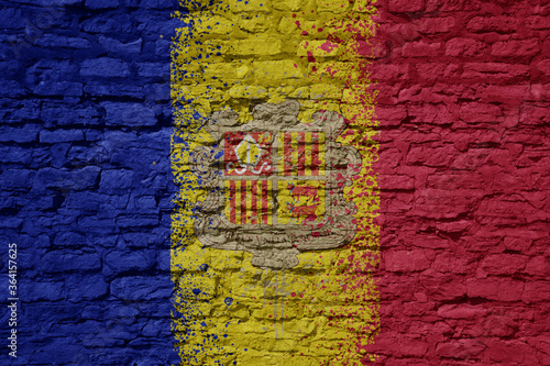 painted big national flag of andorra on a massive old brick wall