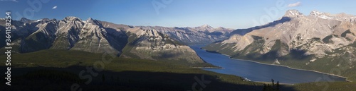 Wide Panoramic Landscape View of Scenic Lake Minnewanka and Rocky Mountain Peaks on a Summertime Hiking Trail in Banff National Park, Alberta Canada