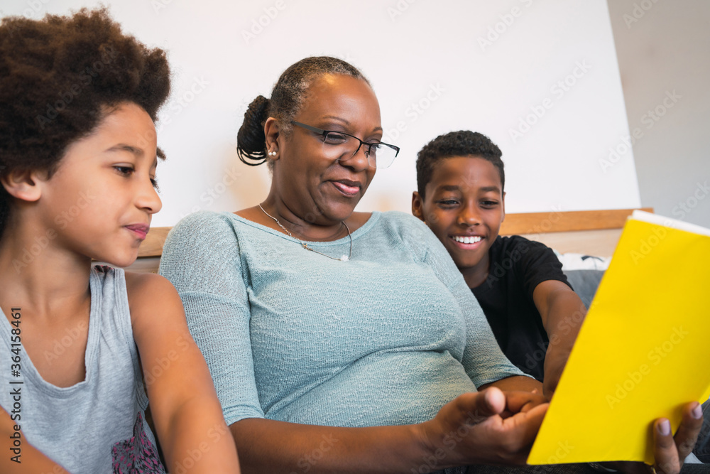 Grandmother reading a book to grandchildren. Grandmother reading a book to grandchildren.