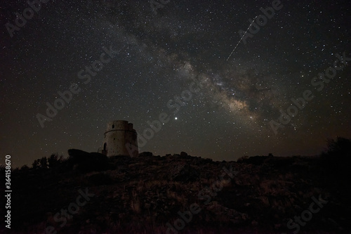Milky way over an old watchtower