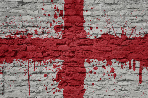 painted big national flag of england on a massive old brick wall