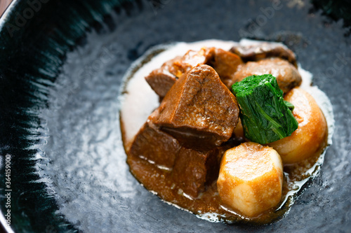 Canvas-taulu Japanese or asian meaty beef stew with simmered potato and spinach in a rustic p