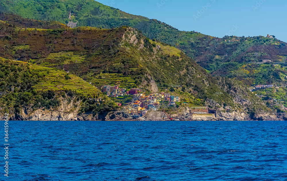 A view along the Cinque Terre coastline towards the village of Manarola, Italy in the summertime