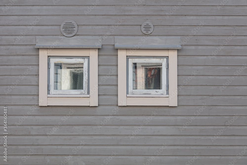Background. Windows in a wooden house. Scandinavian architecture, old houses. Finland.