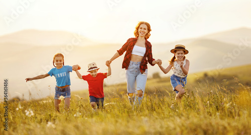 Happy mother with children having fun in countryside.
