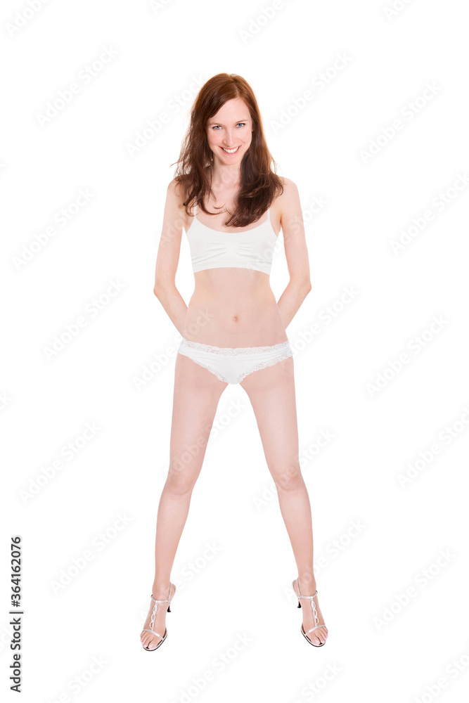 Full length portrait of a smiling woman wearing white lingerie and high heels, isolated on white studio background Full length portrait of a smiling woman wearing white lingerie and high heels, isolated on white studio background