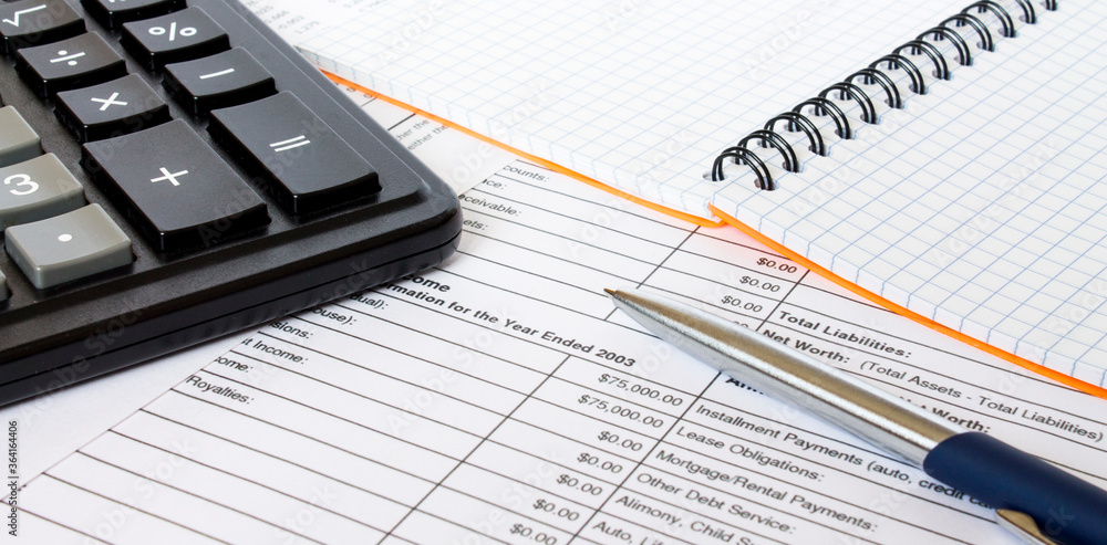 Financial concept. Coins with pen on financial statement Financial concept. Coins with pen on financial statement
