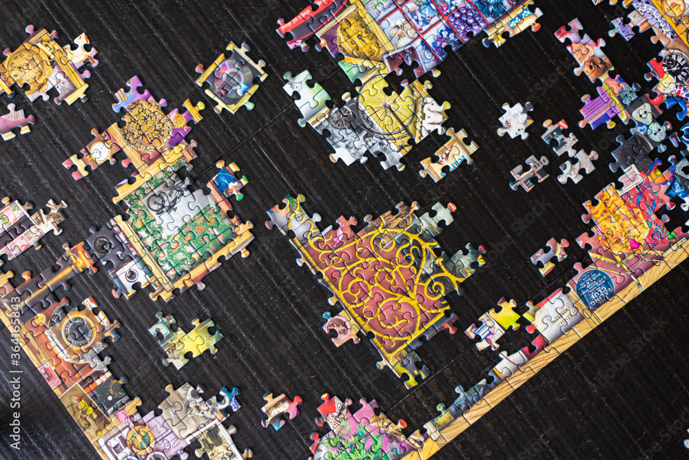 Fototapeta premium A partially completed puzzle on wood table