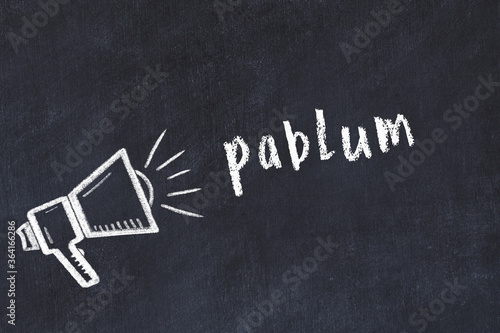 Chalk loudspeaker and inscription pablum on black chalkboard