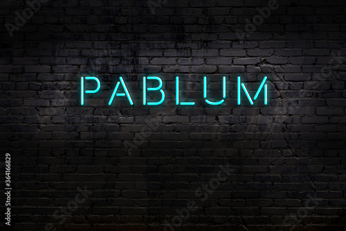 Night view of neon sign on brick wall with inscription pablum