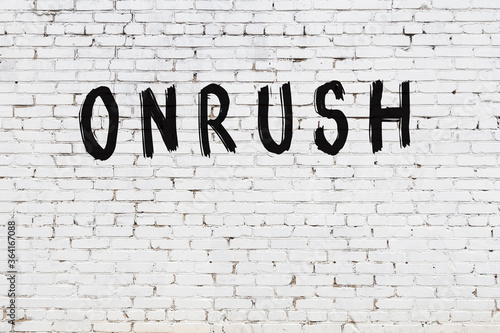 Fotografie Inscription onrush painted on white brick wall