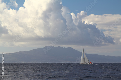 Sailing ship yachts with white sails in race the regatta in the open sea 